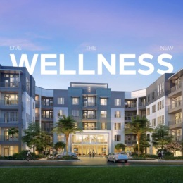 exterior of building with green turf and some seating